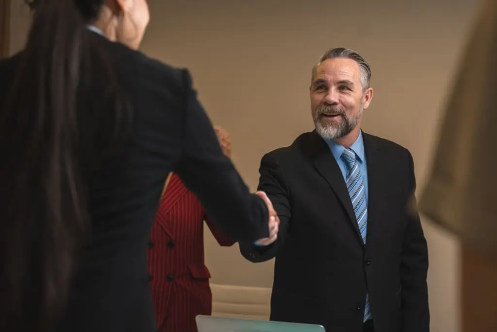 employer shaking the hand of an employee