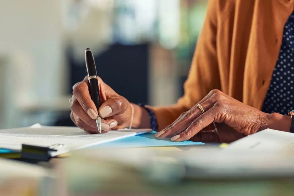 African American woman writing a nursing personal statement